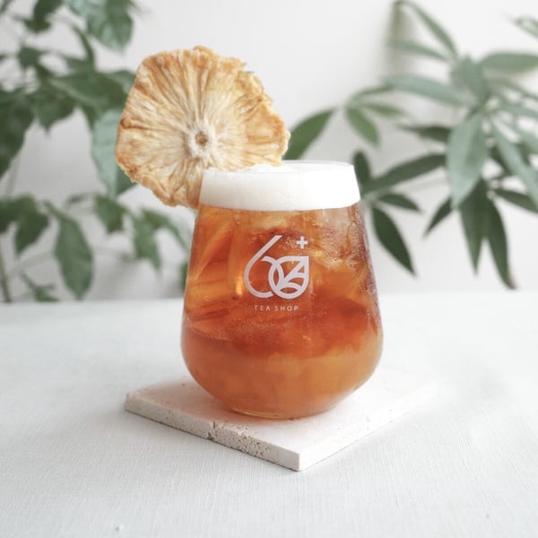 60+ tea shop 的鳳美人飲品，底層可見金黃色的鳳梨果肉。